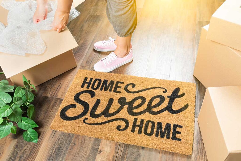 First-time buyers review mortgage documents and home inspection notes at a kitchen table.