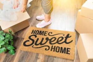 First-time buyers review mortgage documents and home inspection notes at a kitchen table.